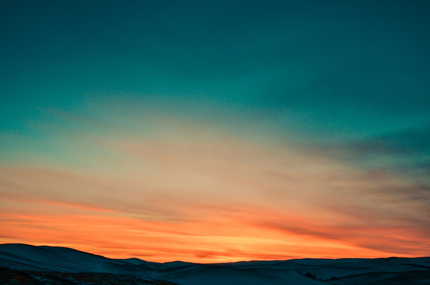 Teal and orange sunset sky — representing clean energy and sustainability
