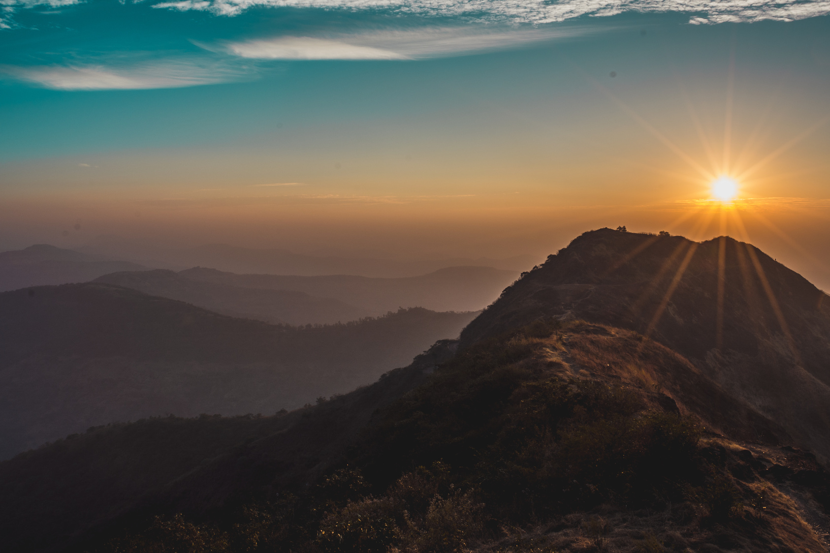Mountain sunrise — representing our environmental commitment