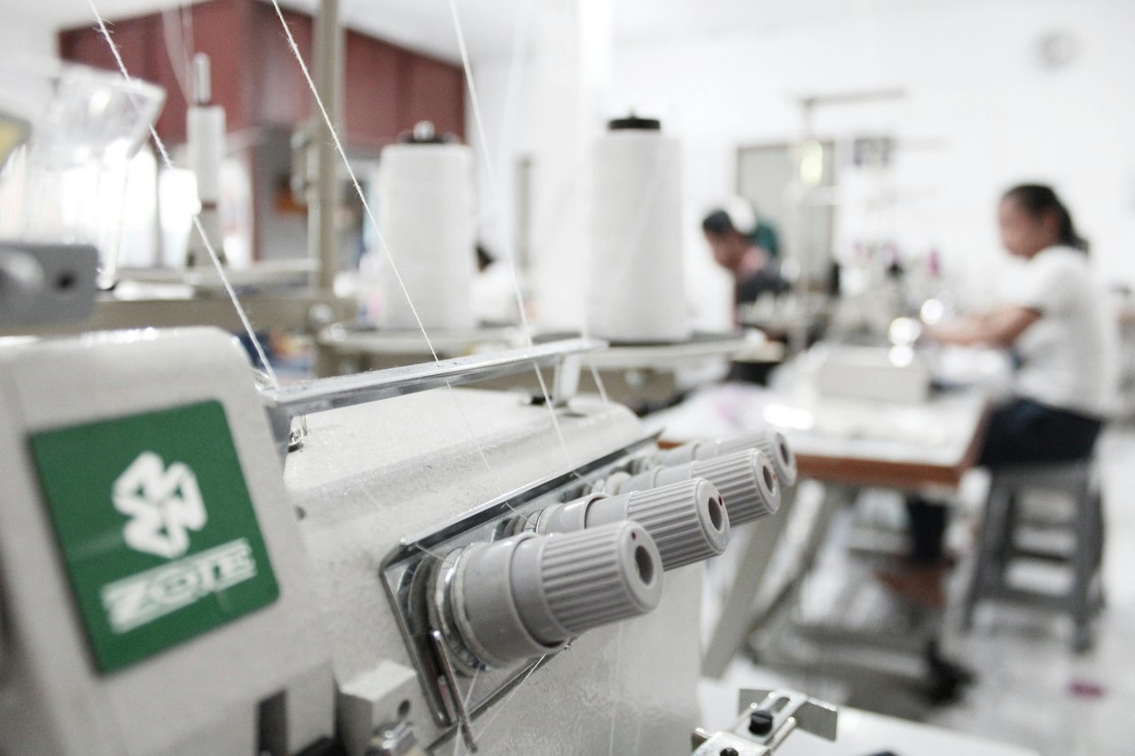 Auditor inspecting fabric production
